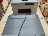 a printer sitting on top of a box in a warehouse
