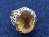a close up of a ring with a large citrine stone in it