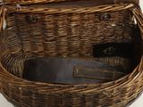 a wicker basket with a pair of shoes inside of it