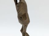 bronze statue of a woman carrying a bowl on her head