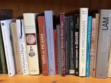 many books that are on a shelf in a book case