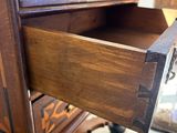 a wooden desk with a drawer on top of it