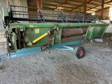 a large green machine that is parked in a building