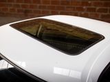 a close up of a car ' s roof with a brick wall in the background