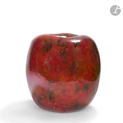 a red apple that is sitting on a white surface