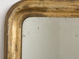 a mirror hanging on a wall with a white wall in the background