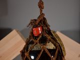 a bottle of wine that is tied up to a wooden box