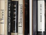 many books that are on a shelf in the room