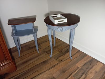 a small table with a book on it next to a chair