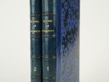 deux livres bleus posés l'un sur l'autre sur une surface blanche