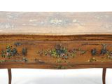 a small wooden table with a floral design on it