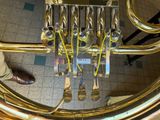 a close up of a brass instrument on a tiled floor