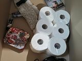many rolls of toilet paper and other items in a box
