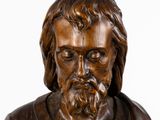 wooden statue of a man with a beard and a cross on his chest