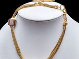 a close up of a necklace on a mannequin mannequin