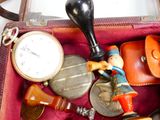 a suitcase filled with assorted items and a clock