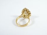 a close up of a gold ring on a white surface