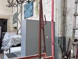 a room with a ladder and a refrigerator in it