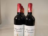 two bottles of red wine sitting on a table