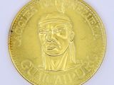 a gold coin with a picture of a man on it