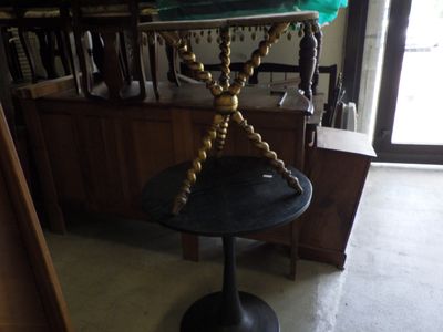 a small table with a glass top and a gold base