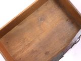 a wooden tray with a metal handle on a white surface