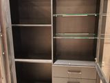 an image of a cupboard with glass shelves in a room