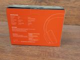 an orange box with a black and white image of a pair of headphones
