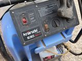 a blue machine that is sitting on the ground