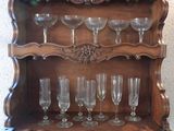 a wooden shelf with wine glasses on top of it