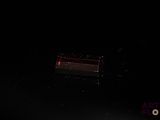 a man riding a skateboard on a ramp in the dark