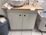 a sink and a trash can in a bathroom
