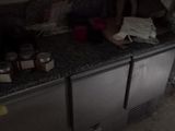 a kitchen with a sink and a refrigerator in it