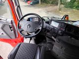 a steering wheel and dashboard of a red truck