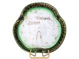 an image of a green and white plate with a picture of a woman on it