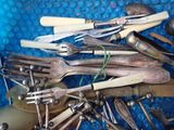 many different types of utensils and spoons in a blue container