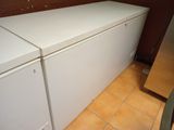 a white refrigerator in the corner of a kitchen