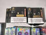 several cigarettes are lined up on a table with a box of cigarettes