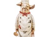 a figurine of a cow wearing a chef ' s hat and apron