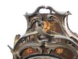 a close up of a clock with a decorative design on it