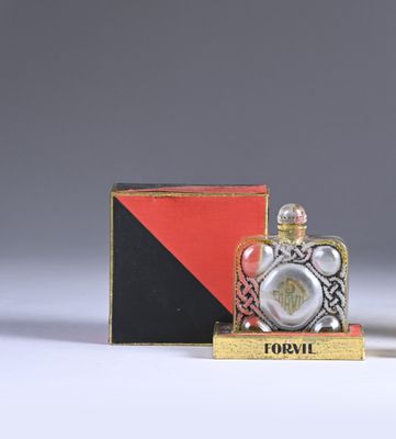 a small bottle of perfume sitting next to a box