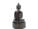 statue of a person sitting in a meditation position on a white background
