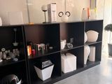 a room with a lot of shelves and vases on it