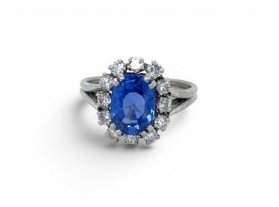 a blue sapphire and diamond ring on a white background