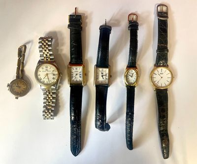 several different types of watches are lined up on a white surface