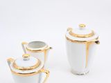 two white and gold teapots with gold trim on a white background