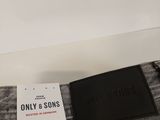a pair of grey jeans with a black label on the back of them