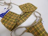 a yellow and green plaid bra top and a tan bag