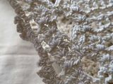 a close up picture of a crocheted blanket on a bed