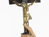 a statue of jesus holding a cross in his hand
